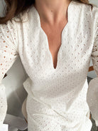 White eyelet bell-sleeve, scallop trim caftan with slits on each side. A classic silhouette. 